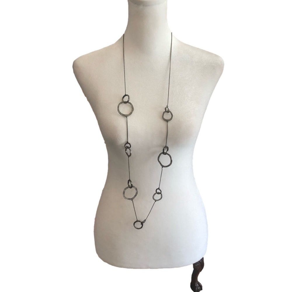 CHICO’S necklace with various shapes and sizes of rings, some with clear stones